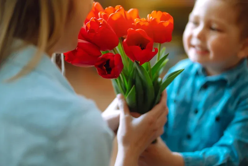 Son gives Mother's Day bouquet with support of positive co-parenting.