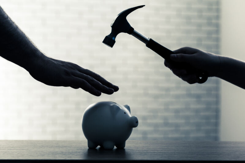 Protecting Assets During Divorce concept | hand protecting piggy bank from hammer raised above