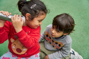 Multiethnic children with Christmas sweater playing in the park